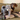 A brown and tan dachshund sat on a green sofa with a plaid blanket and a grey Ancol plush Elephant dog toy sat next to it.