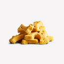 White background with a pile of bone shaped dog treats.
