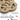 A tan Nina Ottosson dog puzzle toy with food-hiding pegs and callout text explaining how it can be used to feed treats, on a white background.
