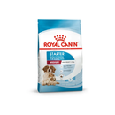 White background with a blue bag of Royal Canin Mother & Babydog. Pictured on the bag is an adult Spaniel dog and two puppies, text on the bag states '1-2months, Medium, Adult weight 11 -25kg'.