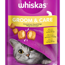 White background with a close up of a purple packet of Whiskas Groom & Care Treats, on the packet is silver tabby cat's face under a purple blanket. Text on the pack reads 'Whiskas Groom & Care, with Zinc & Omega-6 for Skin & Coat.'
