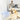 A yellow Labrador retriever lies on a light floor in a bright living room, looking toward a small wall-mounted Adaptil Calm Diffuser on the left that emits a blue sparkling light effect. A blurred man sits on a white sofa in the background.