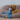 Golden Labrador lying in a fleece bed with a blue and grey standard Ancol Phil the Kraken octopus.