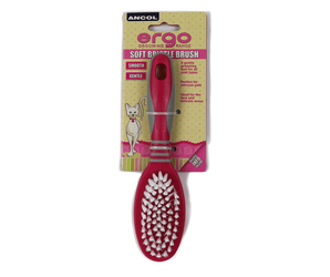 White background with a pink and grey Ergo Soft Bristle Brush for cats, attached to a cardboard backing.