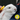 White rabbit being held by someone in a blue jacket, that is off camera. The rabbit is being brushed with a small Ancol yellow brush with white bristles for rabbits. In the bottom corner of the image is a circle with a illustrated rabbit, guinea pig and gerbil, below text says 'For small pets'.