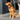 Golden Retriever sat on a decking, wearing a red Ancol Padded collar with a metal buckle and D-ring.