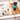 West Highland terrier dog in a bath tub, with a wooden bath rack over the bath. On the bath rack is a black and aqua blue bottle of Animology Spa Day dog shampoo.