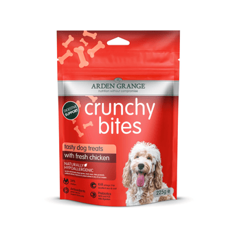 A 225g bag of Arden Grange Crunchy Bites dog treats with fresh chicken, featuring a bright red packaging design with a picture of a fluffy white dog.