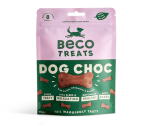 White background with a packet of Beco Dog Treats pictured. On the packet is an illustrated silhouette of a running dog. Text on the pack reads, 'Beco Treats, Dog Choc' with a picture of a bone shaped treat, text below reads 'with Carob, Chamomile & Quinoa, Tail Waggingly Tasty.'