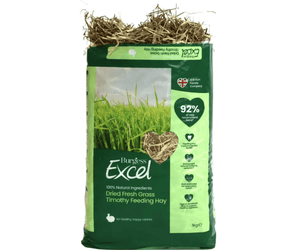 White background with a bag of Burgess Dried Fresh Grass Timothy Feeding Hay. The bag is green with a heart shape window showing the hay inside. Text on the bag reads 'Burgess Excel, Dried Fresh Grass Timothy Feeding Hay.'
