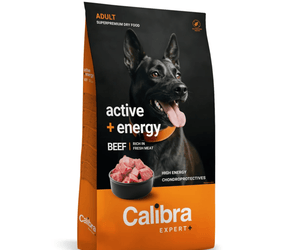 A bag of Calibra Expert+ Adult Active + Energy dog food, featuring a black and orange package with a picture of a black dog and a bowl of raw beef.