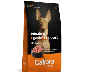 A bag of Calibra Expert+ dog food, specifically 'Sensitive + gastro support' adult dry food in Turkey flavor. The packaging features a black upper section with a photo of a dog's face, and a bright orange lower section with the brand name 'Calibra' in white text.