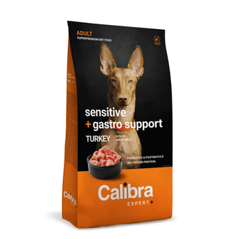 A bag of Calibra Expert+ dog food, specifically 'Sensitive + gastro support' adult dry food in Turkey flavor. The packaging features a black upper section with a photo of a dog's face, and a bright orange lower section with the brand name 'Calibra' in white text.