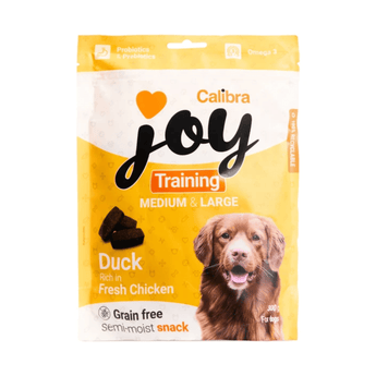 A package of Calibra Joy Training Semi-moist snack dog treats for medium and large dogs, featuring a yellow and white bag with a picture of a brown dog and a duck treat illustration.
