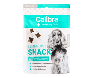 A package of Calibra Veterinary Diets Semi-Moist Snack hypoallergenic dog treats, featuring a white and teal bag with a picture of a grey long-haired dog on the front.