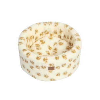 White background with a round cream cat bed with brown pawprints.