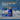 Blue tiled background with a blue bottle of Douxo Ultra-safe Detangling shampoo with orange pump. Text above states 'A spa-like experience for pets and their parents!' Below are blue boxes with white text 'Curved bottle design for good grip, even with wet hands, An easy to use one-handed pump, A hypoallergenic coco-vanilla fragrance.'