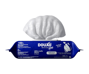 White background with a blue packet of Douxo Ultra-safe pet grooming wipes, with a single wipe sticking out of the packet.
