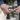 Picture of a person's hands cleaning their Golden Retriever dog's teeth using a white dual ended toothbrush for cats and dogs.