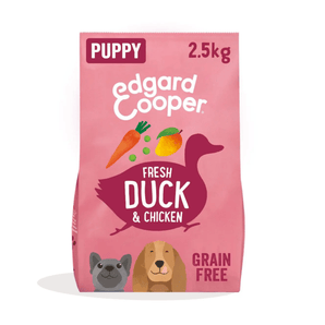 White background with an pink bag of Edgard & Cooper Puppy Dry Food Duck and Chicken pictured. On the packet is an illustrated French Bulldog and Cocker Spaniel puppy. Text on the pack reads, 'Edgard & Cooper.' A silhouette of a duck has text inside 'Fresh Duck and Chicken'.