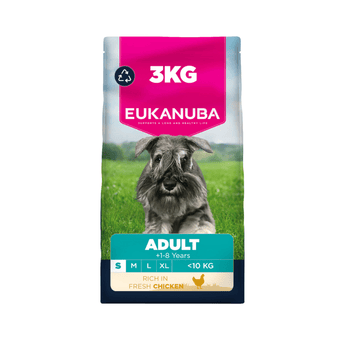 A 3 kg bag of Eukanuba Adult dog food for dogs, featuring a Schnauzer on a green grassy field. The packaging has a bright pink top section with white text, a teal band with product details, and a dark blue base.