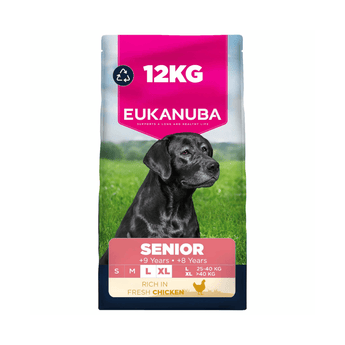 A 12kg bag of Eukanuba Senior dog food, specifically Rich in Fresh Chicken. The packaging features a black Labrador Retriever sitting in a green field, with a bright pink top banner displaying '12KG' and a pink lower banner indicating 'SENIOR'.