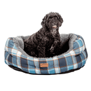 Dog sitting in a blue plaid pet bed with 'Fatface' branding on a white background