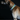 A night time picture of a brown dog wearing the Rainbow Reflective collar.