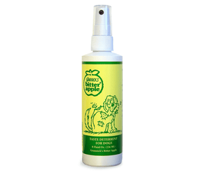 White background with a green spray bottle of Grannick's Bitter Apple Chew Deterrent with an illustrated dog chewing it's own leg on the bottle.