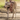 A Weimaraner wearing a red Halti Walking Harness with a person walking behind them on a dirt path.