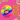 A rainbow-colored furry Fuggler dog toy with a pink tongue and blue and green button-like eyes, shown on a bright pink background with torn-paper edges and brick collage details. Yellow text boxes read 'BONKERS FUGGLER DOG TOY,' 'THE VIRAL TOY.