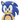 A close up of a jumbo plush dog toy of Sonic the Hedgehog, featuring his classic blue and beige colour scheme with green eyes, shown against a plain white background.