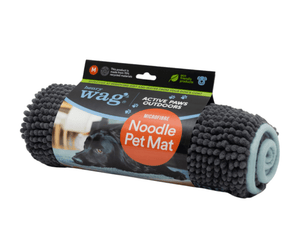Grey microfibre noodle pet mat rolled up in a cardboard sleeve with text 'Henry Wag, Active Paws Outdoors, Microfibre Noodle Pet Mat' with a picture of a black cocker Spaniel lying on a mat. Pictured on a white background.