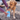 Yellow Labrador on a stony driveway having it's paw cleaned in the blue Henry Wag pet paw cleaner which is being held by a person off screen.