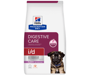A bag of Hill's Prescription Diet i/d Digestive Care Puppy dog food, featuring a white bag with a dark purple label, a picture of a puppy, and the Hill's logo.