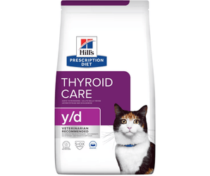 Hills Prescription Diet Y/D Thyroid Care dry cat food packaged in a white bag with an adult tortoiseshell and white cat pictured on the bag. Text on bag says 'Hill's Prescription Diet, Thyroid Care' and 'Y/D', Veterinarian recommended' pictured on white background.