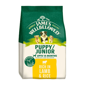 White background with a bag of James Wellbeloved Lamb & Rice Puppy/Junior Food. Packaging is green and cream with 3 puppies pictured, with text 'Puppy/Junior ,Upto 14 months, Rich in Lamb & Rice'.