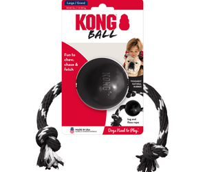 White background with a pack of a black KONG Extreme Dog Ball with rope pictured on the pack is a boy with a Bulldog.