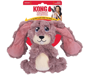 White background with a KONG Scrumples Bunny dog toy, the main body is made from faux fur body with a cream belly and muzzle with stitched features attached to a cardboard backing.