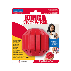 White background with a pack of one red KONG Stuff-a-Ball dog ball, pictured on the pack is a girl holding a Labrador dog.