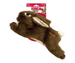 White background with a KONG Wild Low Stuff Rabbit dog toy, the main body is made from brown faux fur body with cream belly and inner ears with stitched features attached to a cardboard backing.