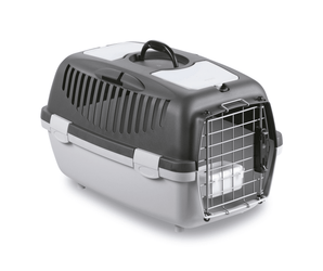 White background with a Krusse Stefanplast size 2 Travel Crate. The crate is light and dark grey plastic with a closed metal door.