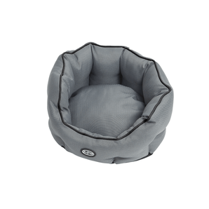 Oval donut-type grey dog bed with black piping pictured on a white background.