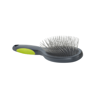 White background with a small grey plastic brush with green padded handle and metal bristles facing up pictured.