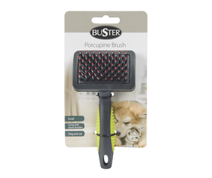 White background with a black BUSTER Porcupine Brush with green grips on the handle attached to a cardboard backing.