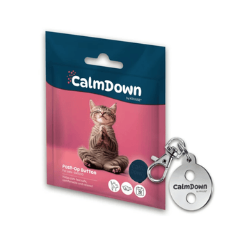 CalmDown post-op button keychain shown next to its retail packaging. The packaging features a pink and dark blue design with a picture of a sitting cat.