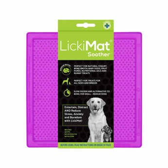 White background with a purple LickiMat Soother slow feeder mat with a bobbly surface. The Soother mat is in black and green packaging cardboard packaging.