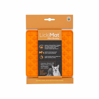 White background with a orange LickiMat Mini Buddy slow feeder mat with a criss-cross surface. The Playdate mat is in black and orange packaging cardboard packaging.