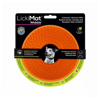White background with a orange LickiMat Wobble slow feeder with a bobbly internal surface. The Wobble bowl is in black cardboard packaging.