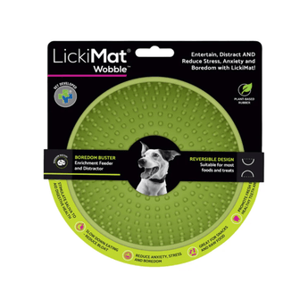 White background with a green LickiMat Wobble slow feeder with a bobbly internal surface. The Wobble bowl is in black cardboard packaging.